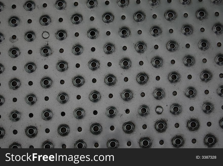 Grey background with small and big holes. Grey background with small and big holes