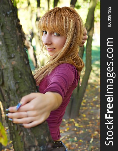 Slim cute blond girl in the autumn park. Slim cute blond girl in the autumn park