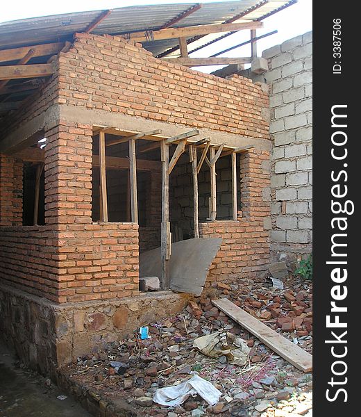 Within the ruins of an older brick school, a new building is being built in Kigali Rwanda. Within the ruins of an older brick school, a new building is being built in Kigali Rwanda.