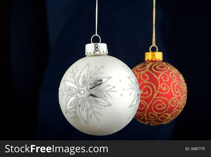 Red and silver Christmas decoration isolated on blue/black background. Red and silver Christmas decoration isolated on blue/black background