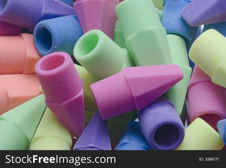 A closeup of a pile of colorful erasers.