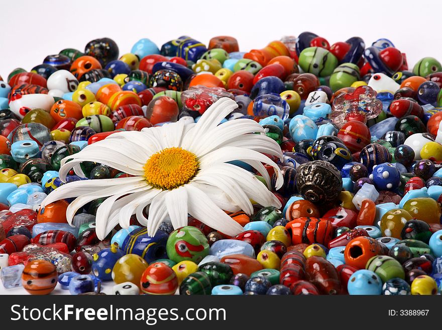 Colorful beads and big daisy flower. Colorful beads and big daisy flower