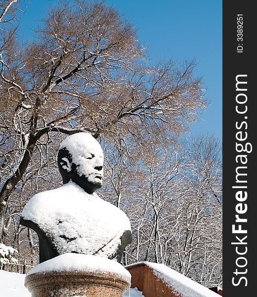 Snow statue of russian admiral kuznetsov in vladivostok town park. Winter seasonal view with snow trees and blue sky. Snow statue of russian admiral kuznetsov in vladivostok town park. Winter seasonal view with snow trees and blue sky.