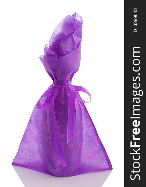 A gift wrapped wine bottle over a white background