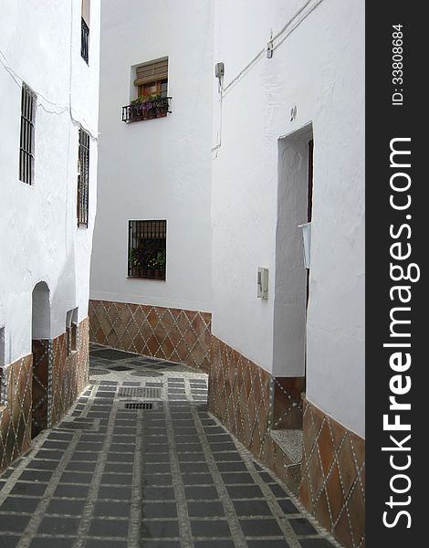 Moorish street with homes and cobbles, Andalusia
