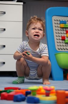 A Baby Boy Crying In Children Room Stock Images
