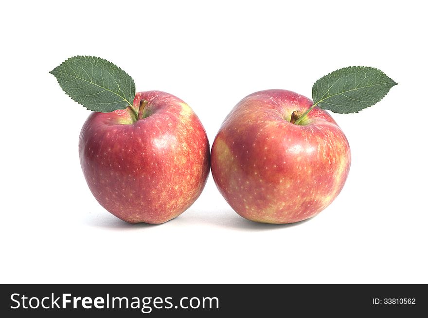 Two sweet red apple with leaf on isolated background. Two sweet red apple with leaf on isolated background