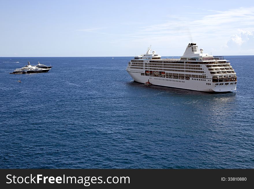 Cruise liner and yachts in the clear blue Mediterranean sea near the coast of Monaco. Cruise liner and yachts in the clear blue Mediterranean sea near the coast of Monaco