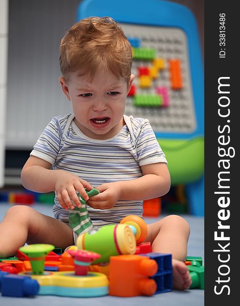 A baby boy crying in children room