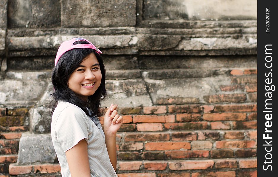 Pretty Girl Standing Near Brick Wall Background