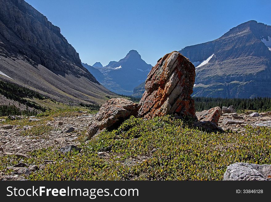 This image show a portion of the Siyeh Drainage in Glacier National Park with Reynolds Mountain in the far background. This image show a portion of the Siyeh Drainage in Glacier National Park with Reynolds Mountain in the far background.