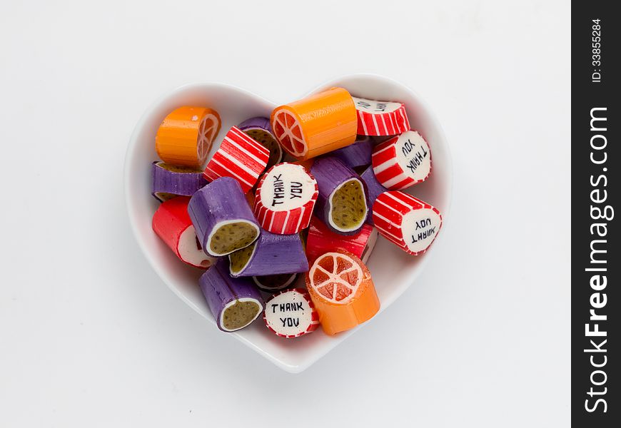 Heart-shaped plate with different candies. Heart-shaped plate with different candies