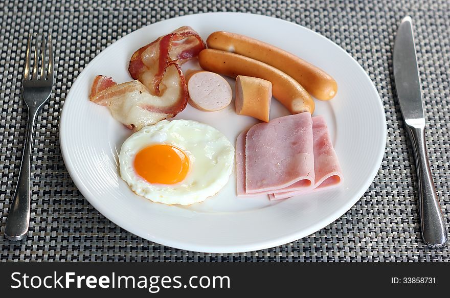 Breakfast meal with ham ausage bacon and egg