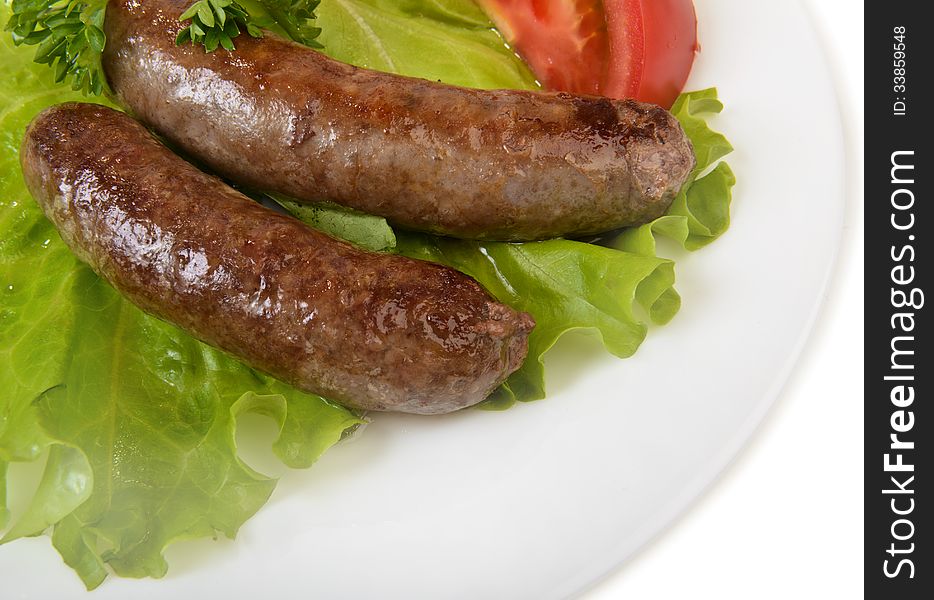 Barbecue grilled sausage on white plate