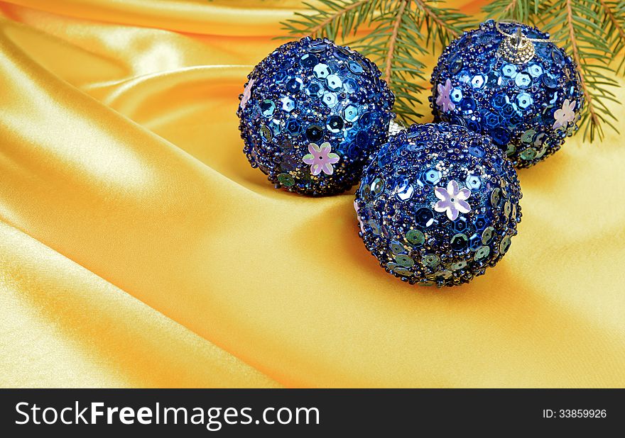 Christmas ball and pine tree branch decoration on yellow silk. Christmas ball and pine tree branch decoration on yellow silk