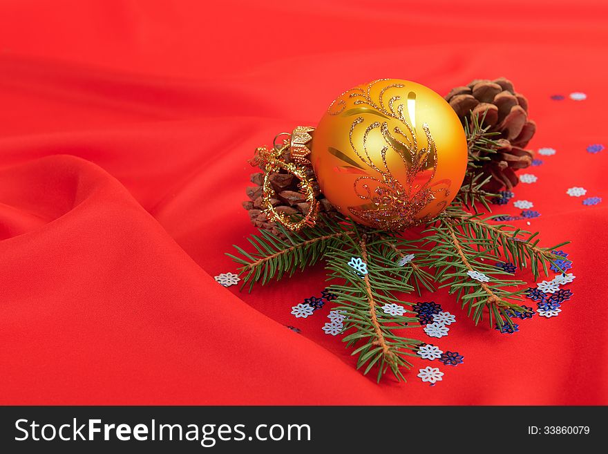 Christmas ball and pine tree branch decoration on red silk. Christmas ball and pine tree branch decoration on red silk