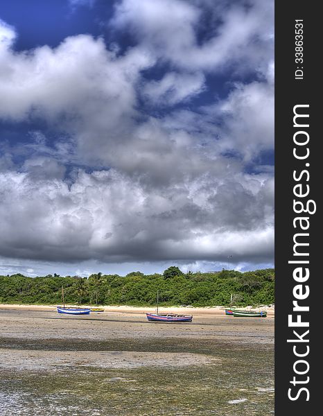 There are a few boats beached on the beach in Mozambique in the vilanculos area. There are a few boats beached on the beach in Mozambique in the vilanculos area.