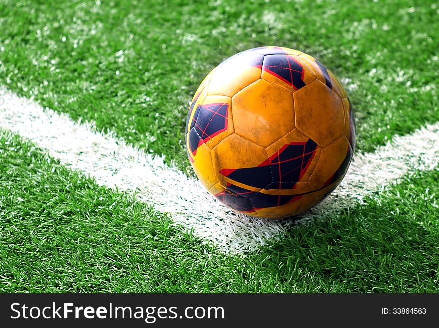 Old soccer ball on the soccer field