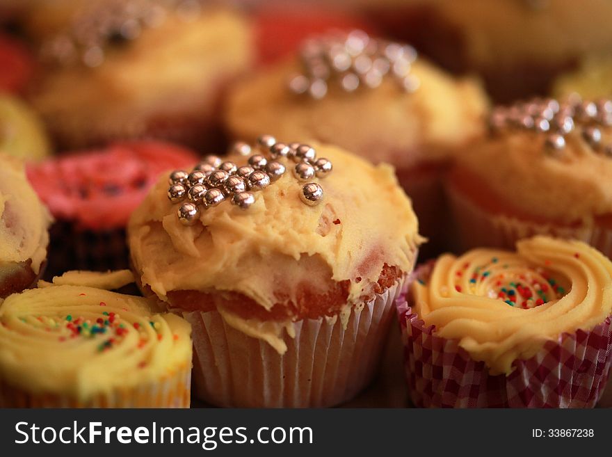 Various cupakes with silver balls and sprinkles. Creative background blur. Various cupakes with silver balls and sprinkles. Creative background blur