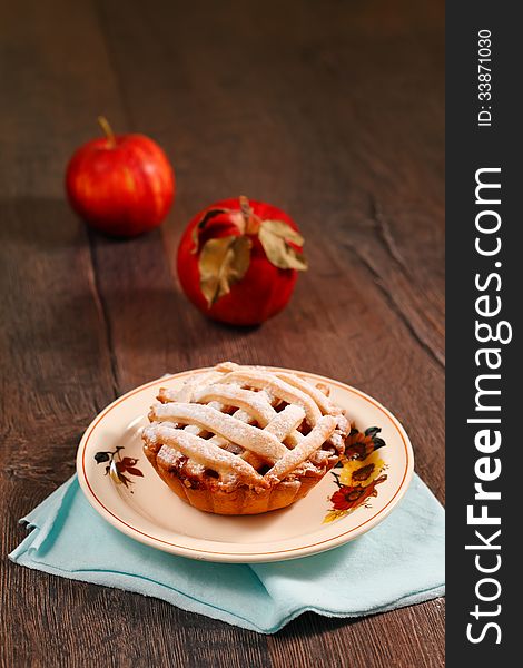 Small apple pie on wooden table