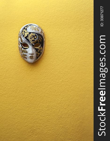 Beautiful elegant venetian mask on orange wall background