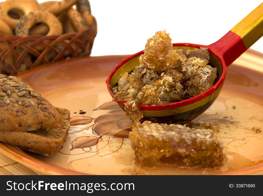 Spoon honey comb large platter decorative old barrel honey colored slices bread with sesame poppy drying basket isolated on white background