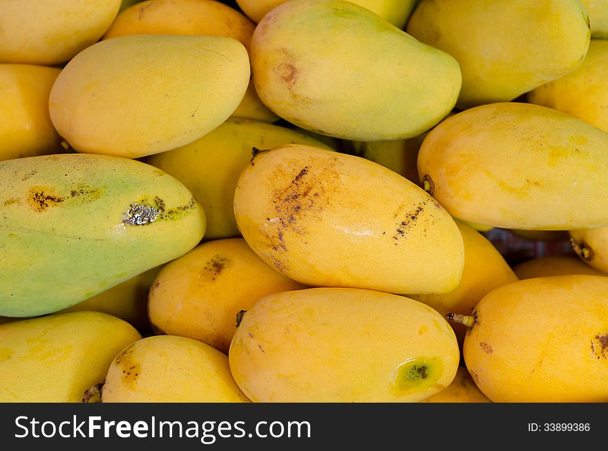 Yellow mango on market closeup