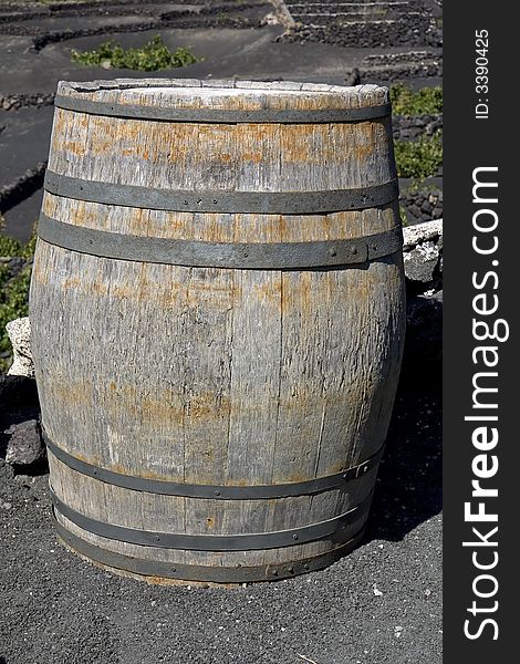 Old wine barrel in a vineyard in Lanzarote, Canary Islands. Old wine barrel in a vineyard in Lanzarote, Canary Islands