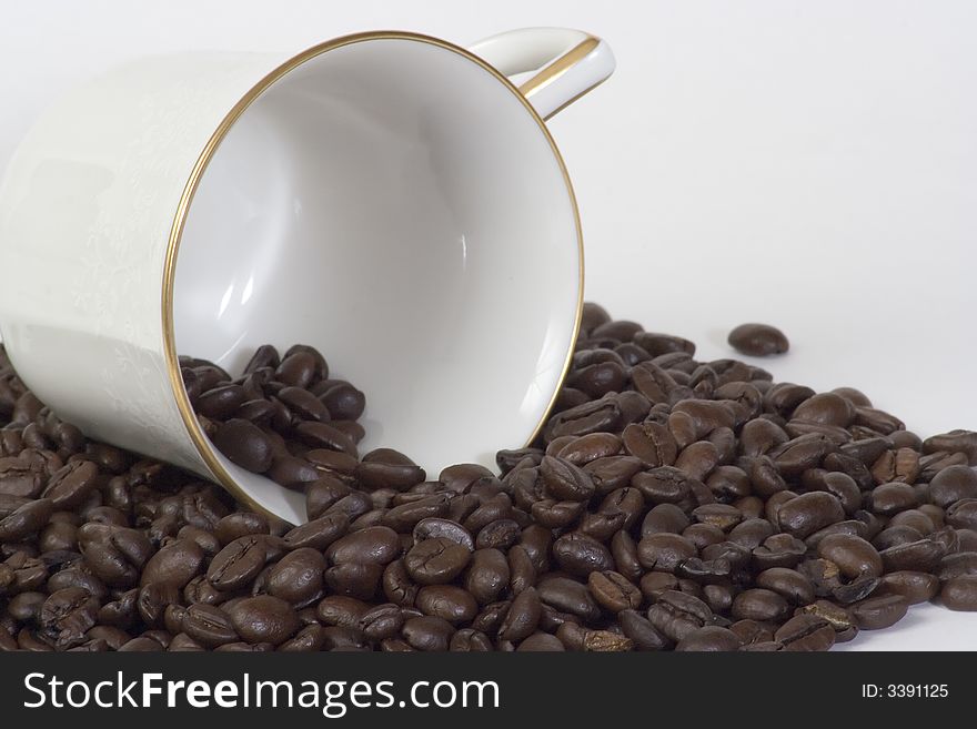 Coffee Cup Laying In Beans