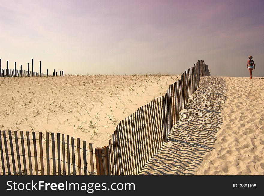 A woman walking down to Navarre Beach, Florida. A woman walking down to Navarre Beach, Florida.