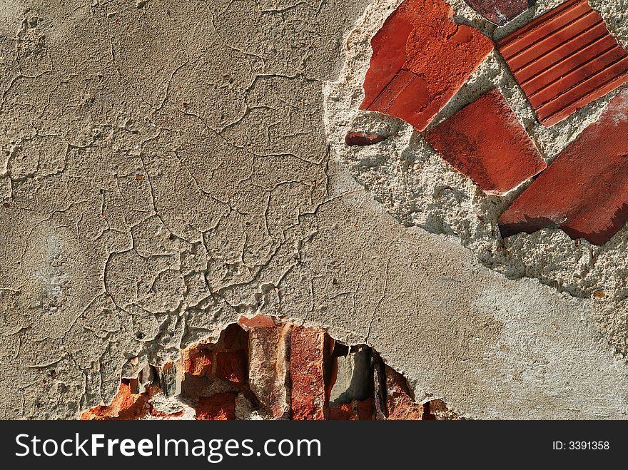 Fragment of a brick wall with the broken plaster. Fragment of a brick wall with the broken plaster