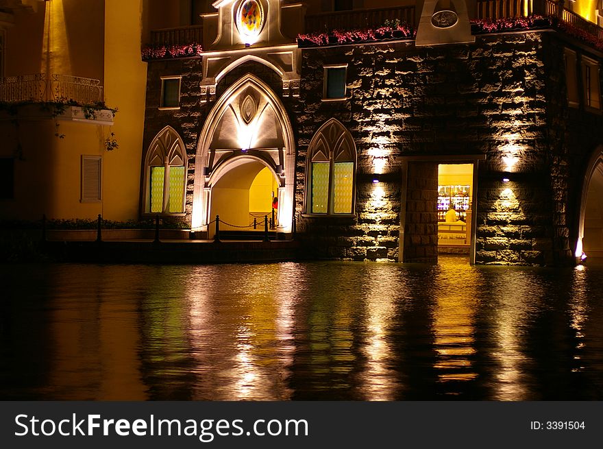 A castle building at night on a lake with lights reflecting on the water. A castle building at night on a lake with lights reflecting on the water