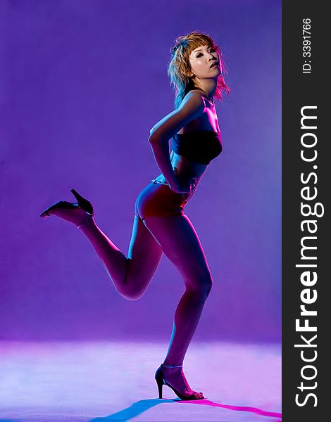 Blue red lighting of a dance move of a young female. Blue red lighting of a dance move of a young female