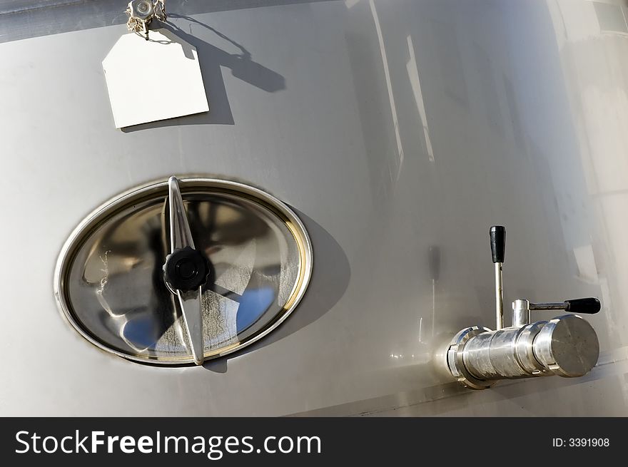 Detail of a stainless steel reservoir in a wine cellar, Portugal. Detail of a stainless steel reservoir in a wine cellar, Portugal