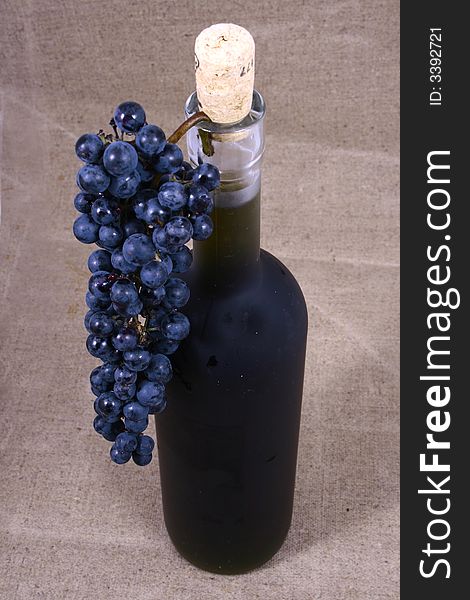 Bottle And Grapes Isolated On