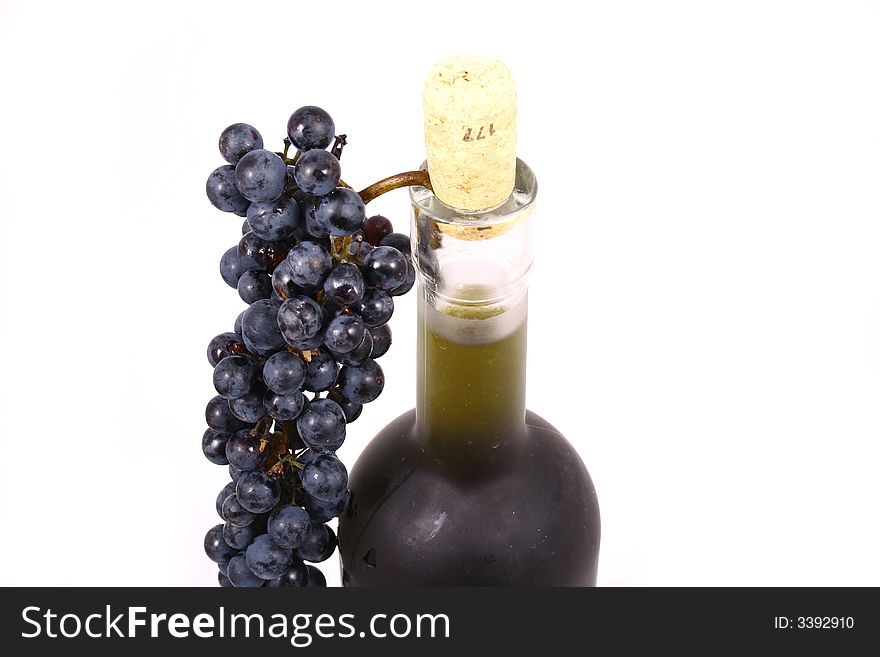Bottle and grapes isolated on white
