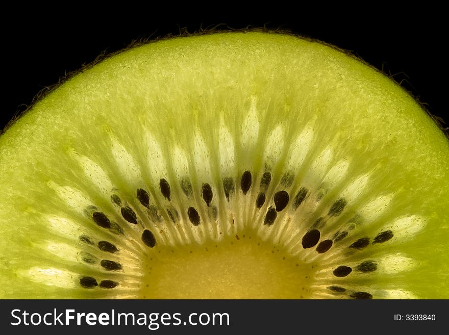 Half kiwi slice isolated on black