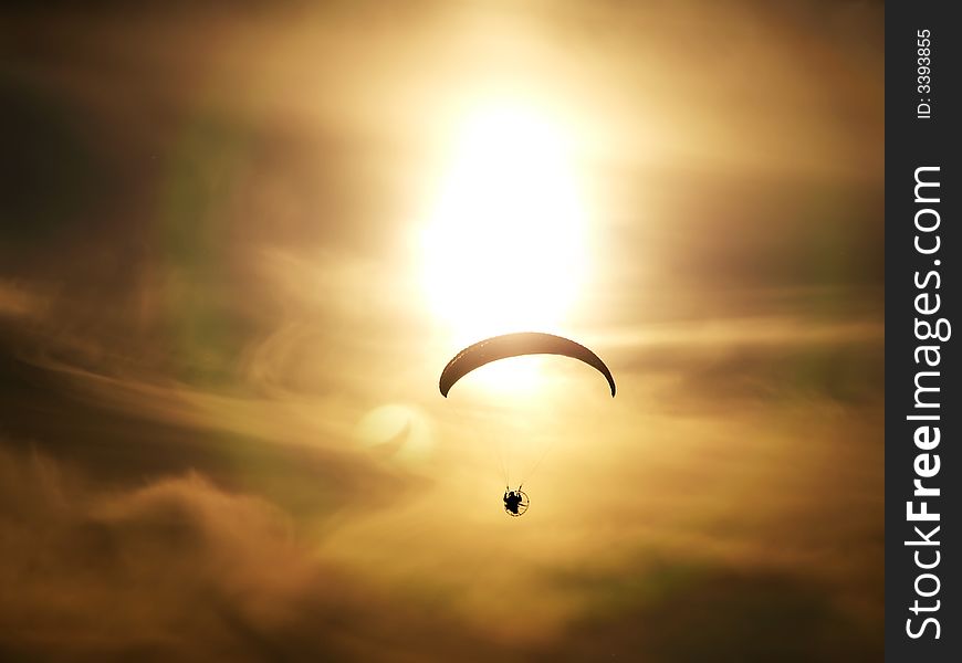 Motor kite sailor wind sailing on a dusky sunset. Motor kite sailor wind sailing on a dusky sunset