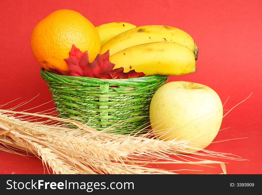 Food and green basket with red background. Food and green basket with red background