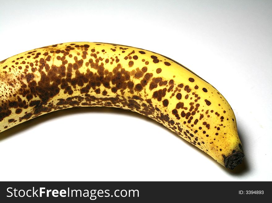 A very ripe banana with a lot of interesting detail