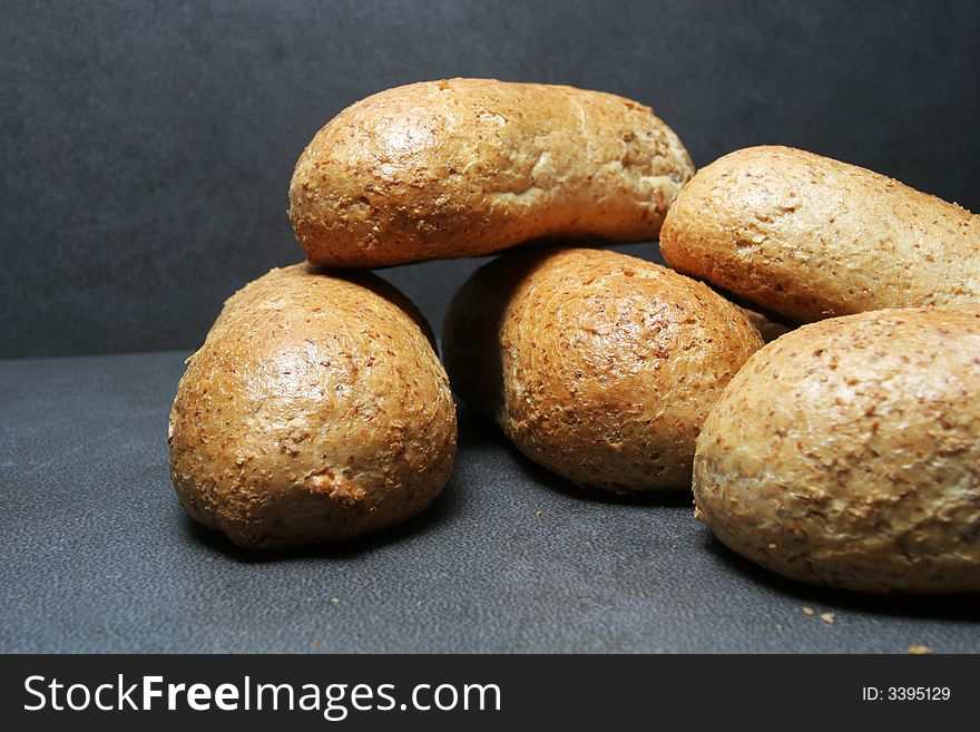 Fresh bread buns on grey tiles. Fresh bread buns on grey tiles