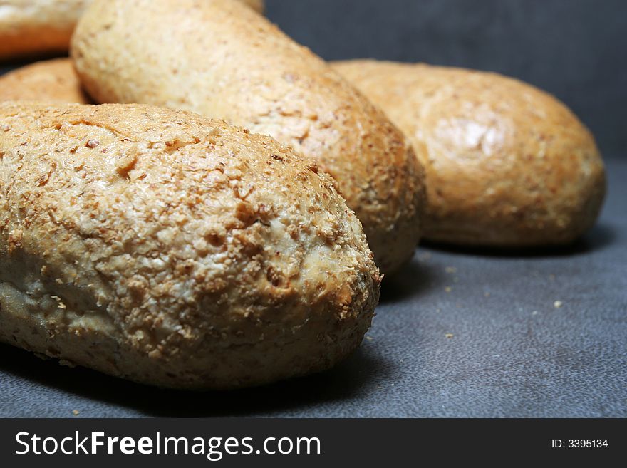 Fresh bread buns on grey tiles. Fresh bread buns on grey tiles