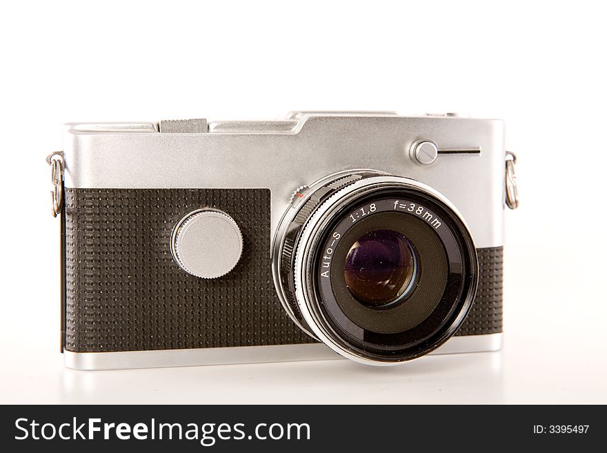 A silver and black retro point-and-shoot camera isolated on white. A silver and black retro point-and-shoot camera isolated on white.