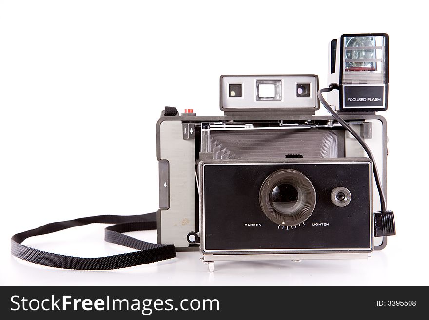 A retro bellows point-and-shoot camera with a flash isolated on white. A retro bellows point-and-shoot camera with a flash isolated on white.