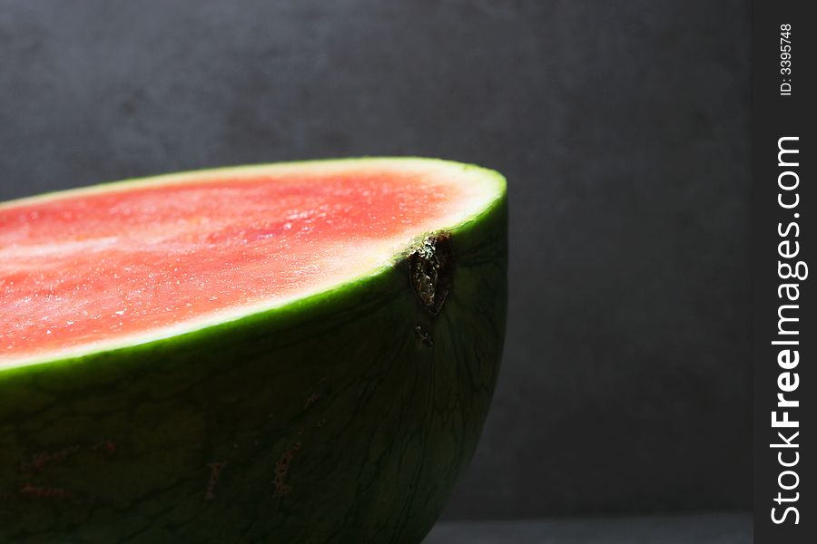 Cut watermelon on a dark grey background. Cut watermelon on a dark grey background