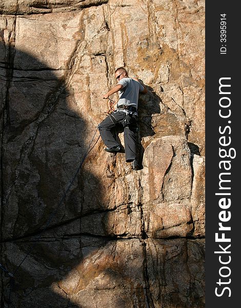 Climber leading a climb in Prescott Arizona along Watson Lake's Granite Dells. Climber leading a climb in Prescott Arizona along Watson Lake's Granite Dells.