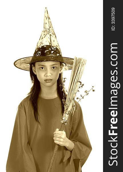 A young girl dressed in a witch costume