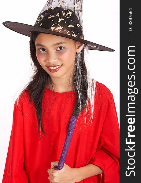 A young girl dressed in a witch costume
