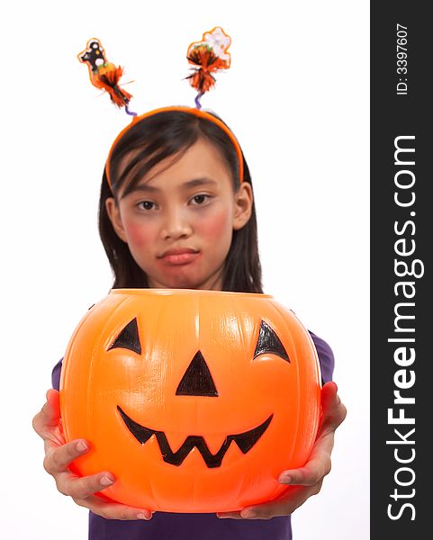 A sad face girl holding a pumpkin over a white background. A sad face girl holding a pumpkin over a white background