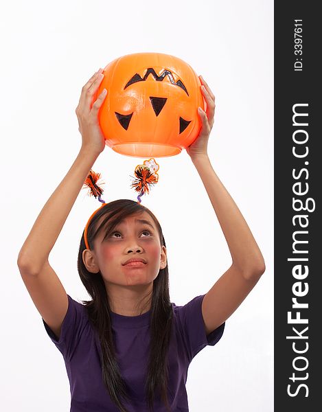 A girl looking at her empty pumpkin over a white background